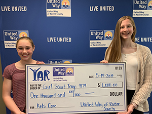 A photo of YAR students holding a check.