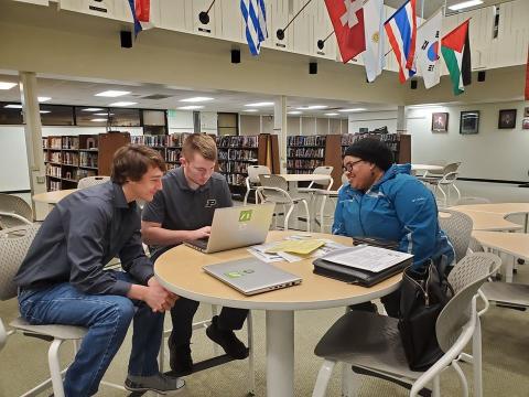 Volunteer tax preparers assisting a taxpayer at a VITA site.