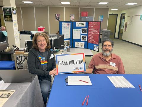 Two VITA volunteers welcoming clients as greeters.