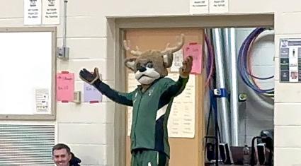 Milwaukee Bucks mascot Bango appears in a school gymnasium